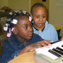 Daejanay and Sterling (both 6 years old) improvising on keyboard, photo by Sarah Greene 2004
